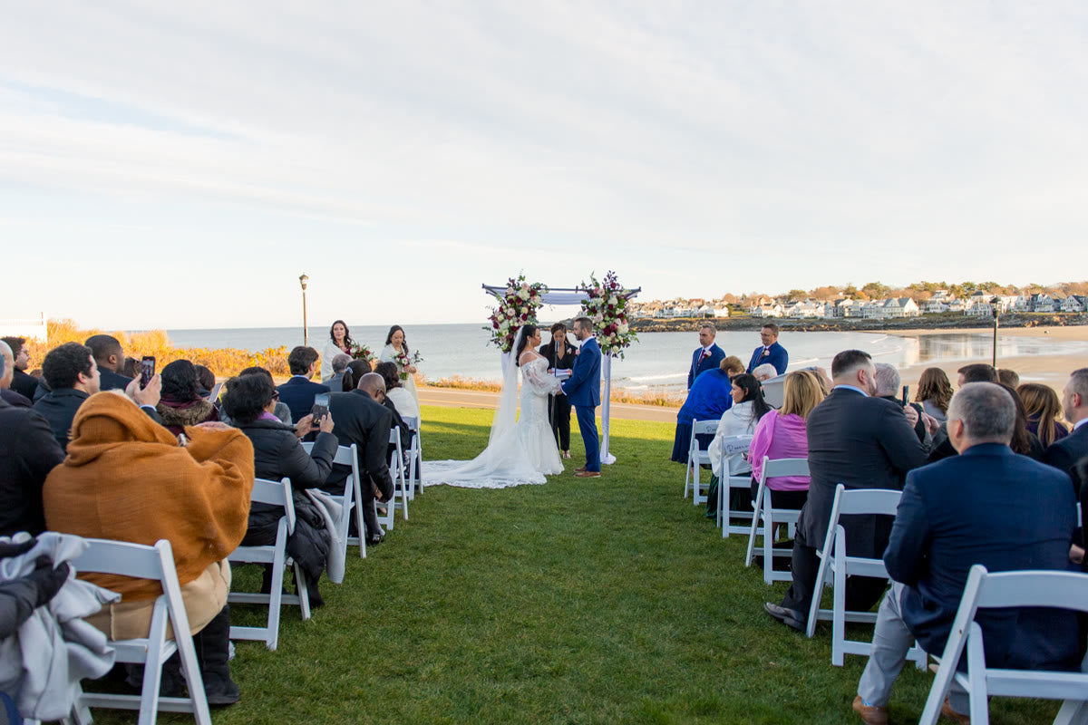 The oceanfront ceremony, guests seated on the lawn