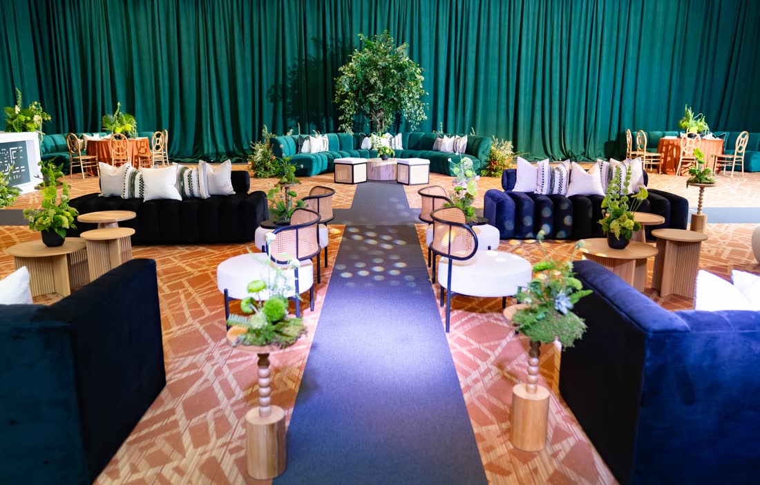 Emerald lounge installation with a runway of greenery
