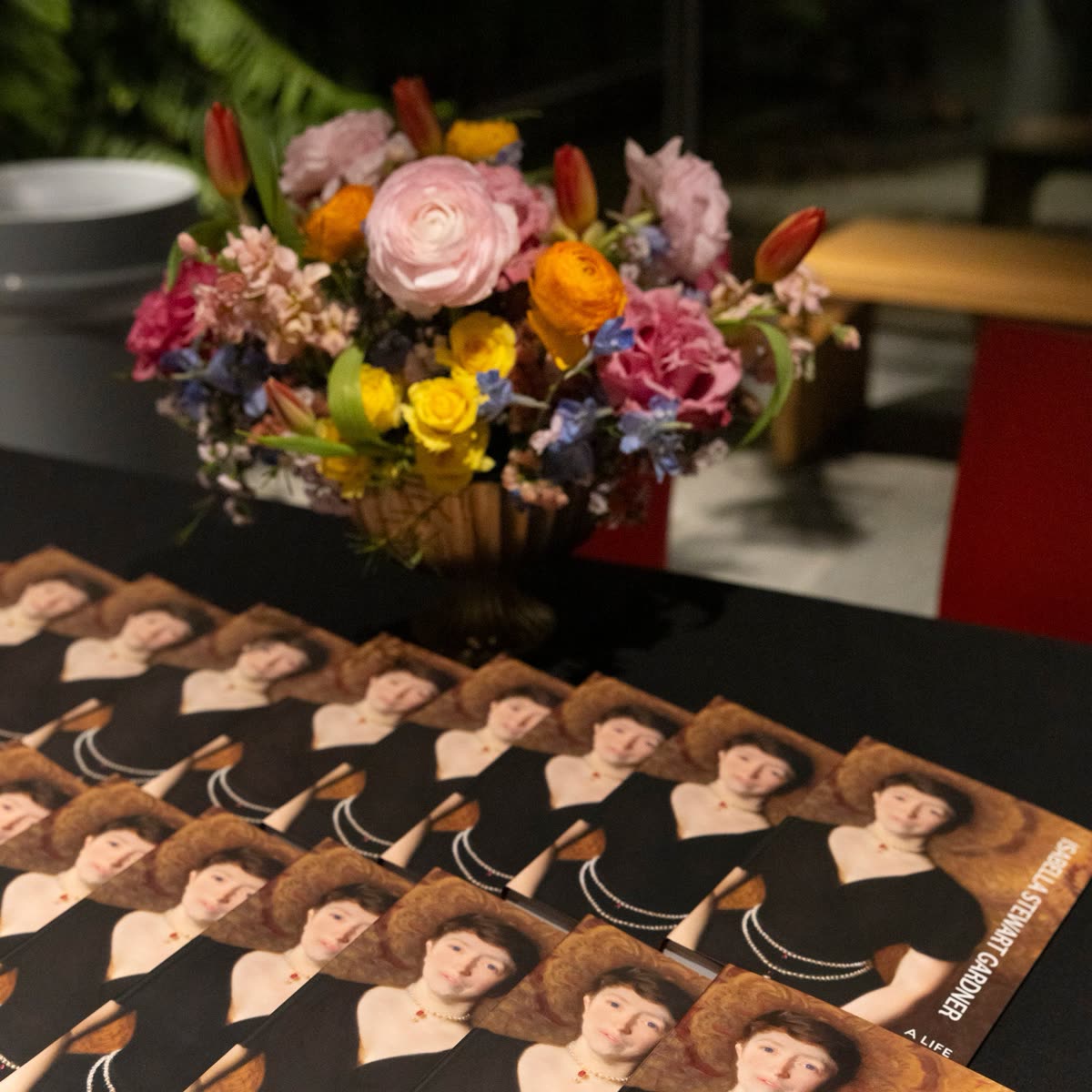 Florals beside stacked gala programs
