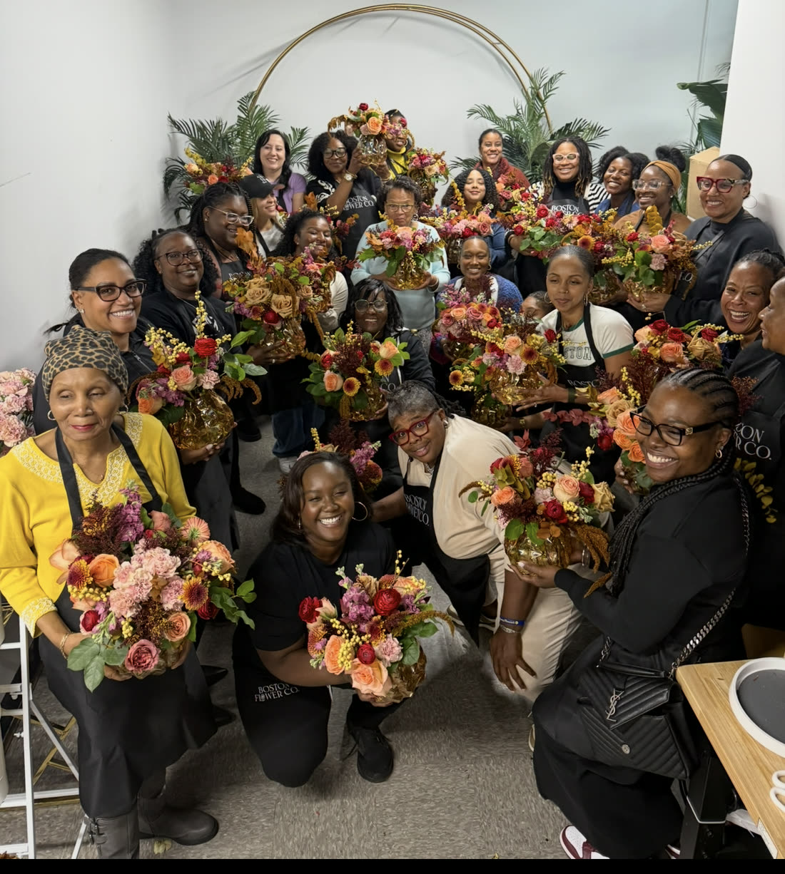 A private group workshop, everyone holding finished arrangements