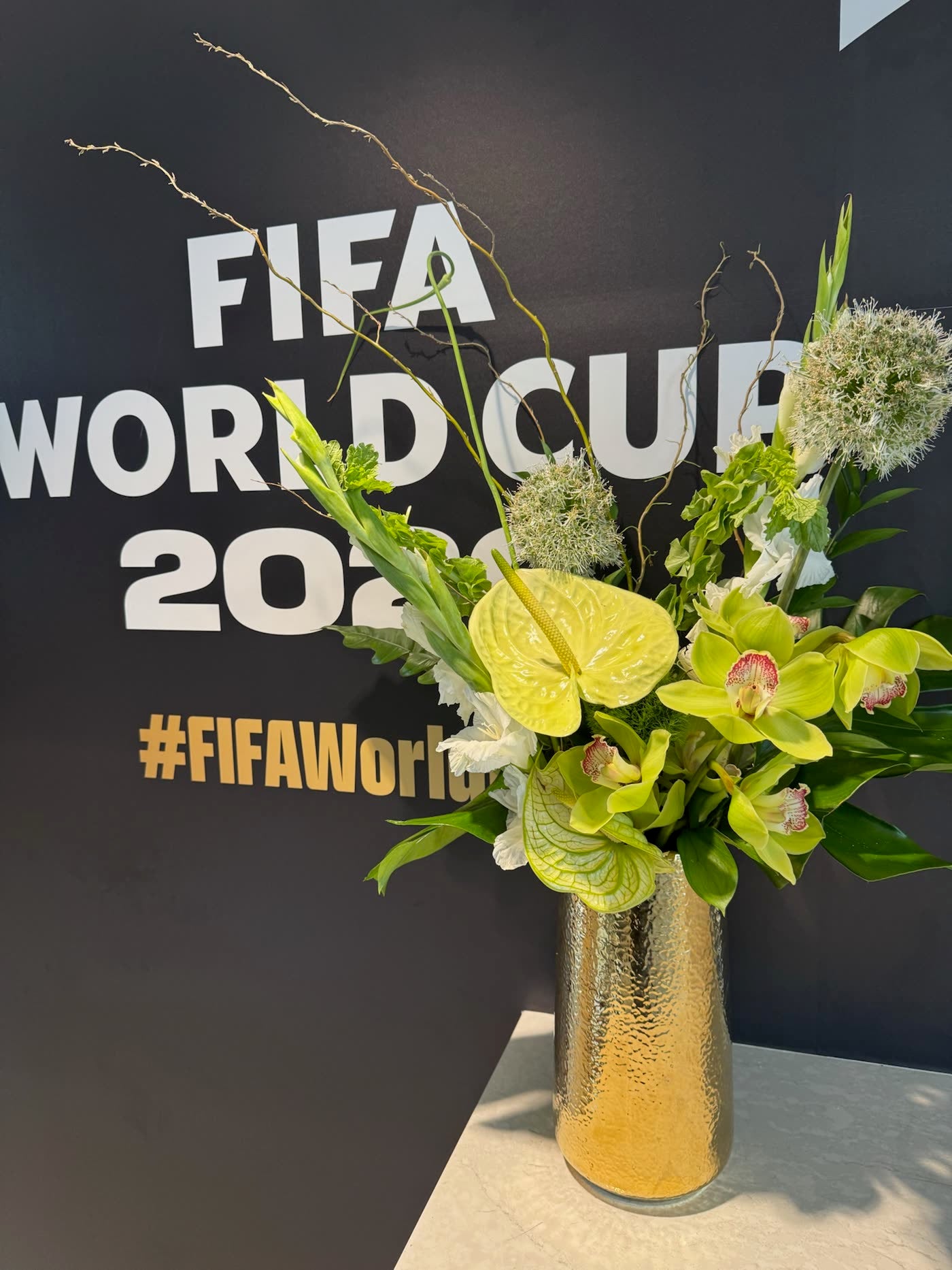 Green orchid and hydrangea arrangement at the FIFA World Cup 2026 wall