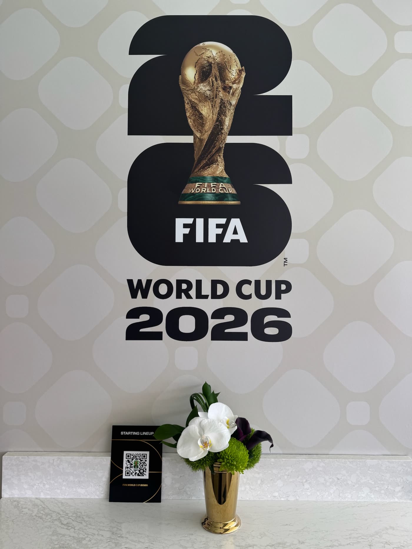 White orchid posy beneath the World Cup trophy mark
