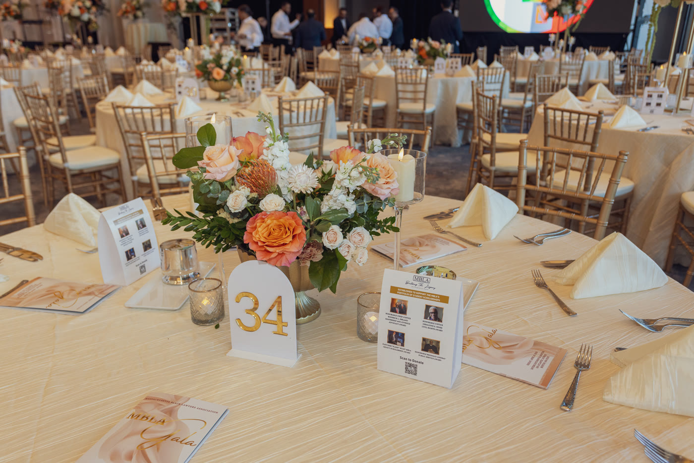 Peach centerpiece and gala programs at table 34