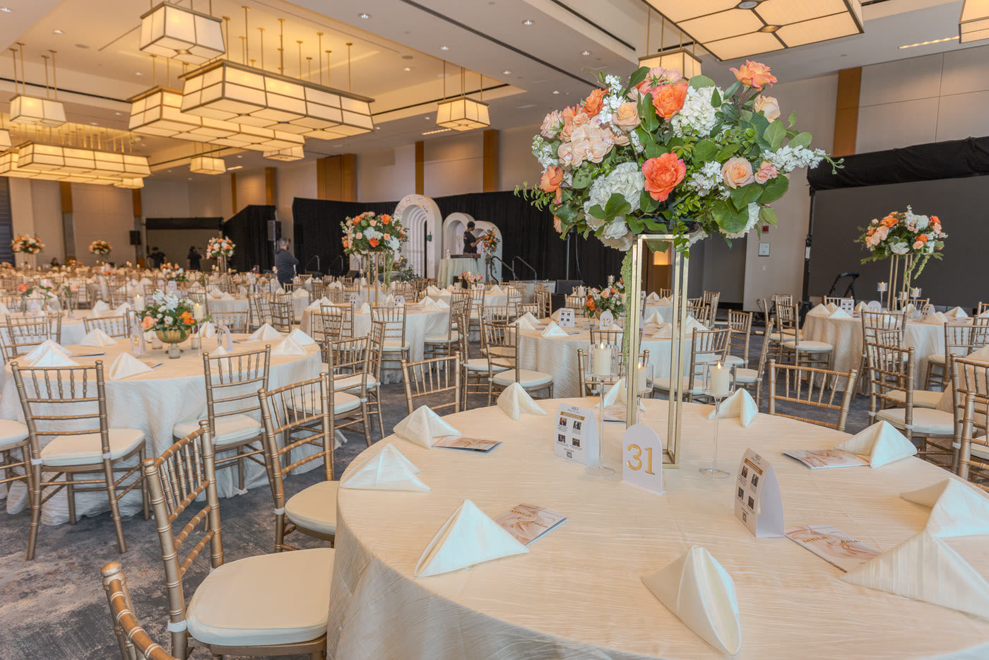 Tall peach arrangements over the gala ballroom