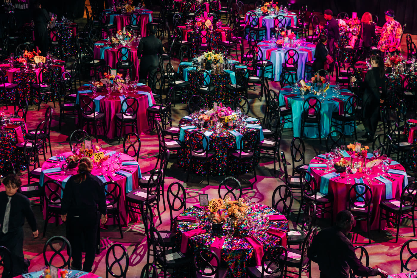 Pink and teal tables set beneath the mirror balls