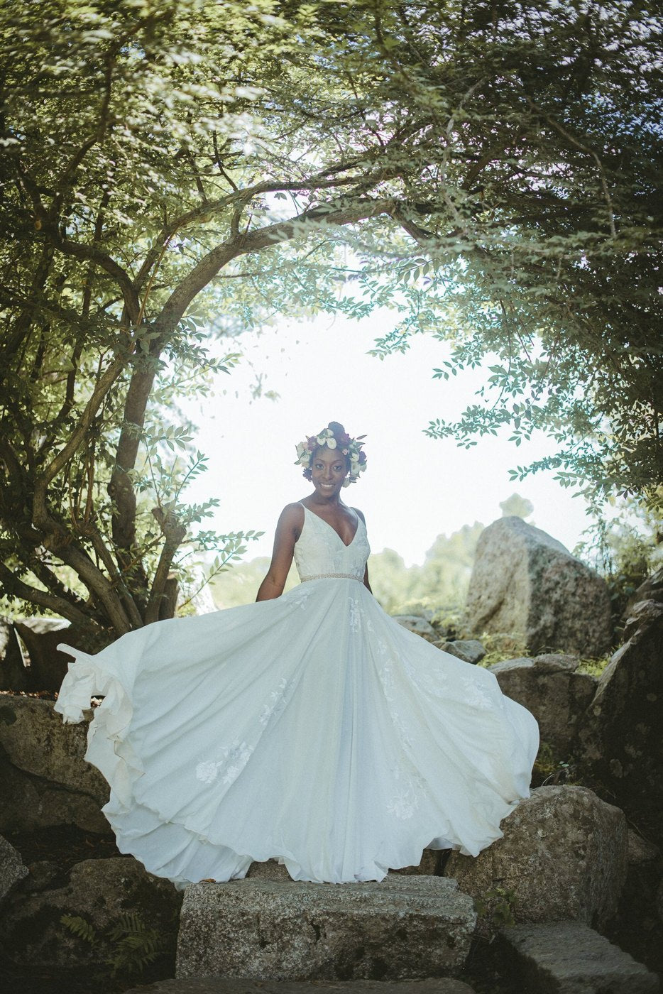 The bride mid-twirl beneath the trees