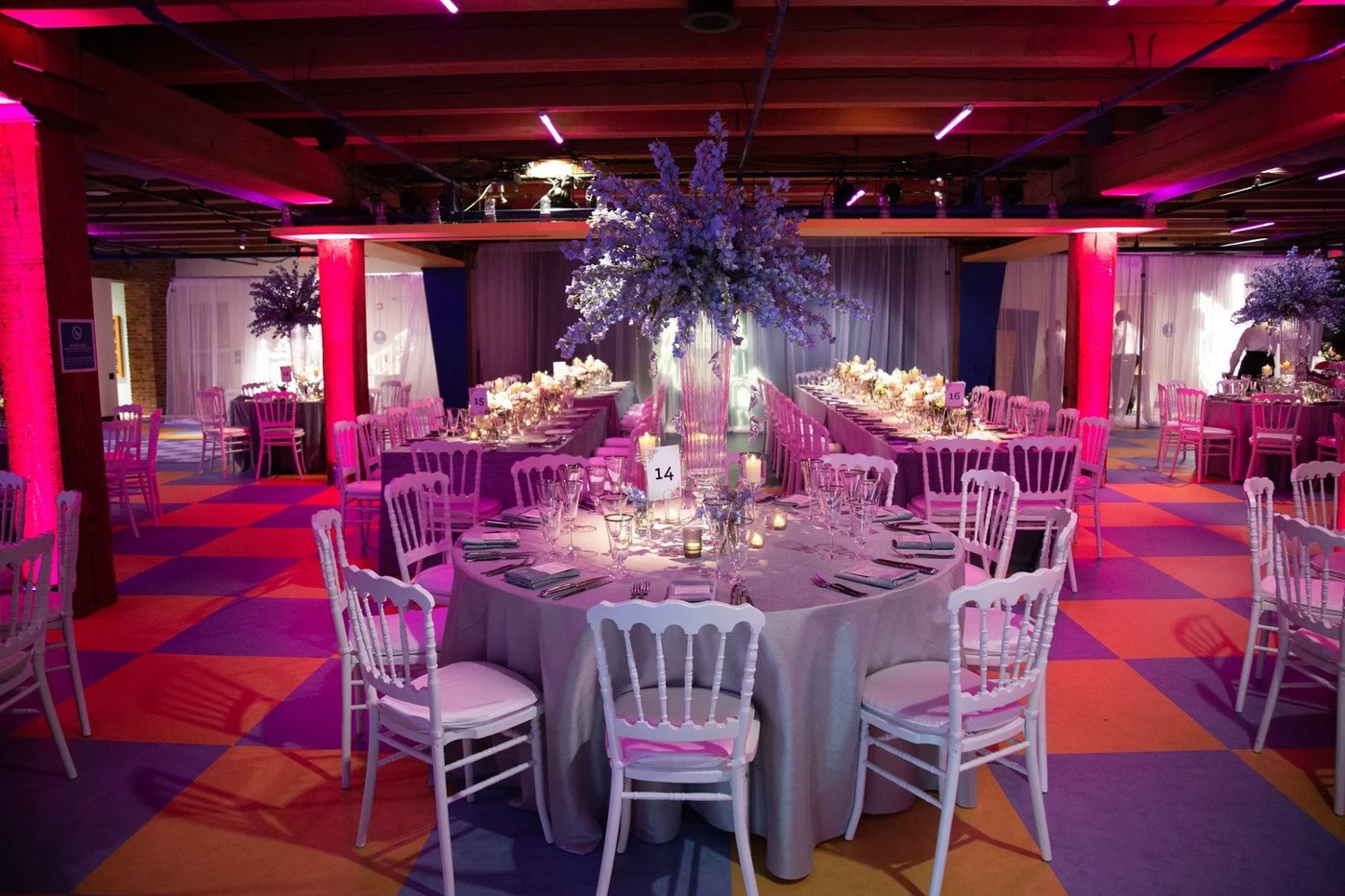 The ballroom in violet light over a checkerboard floor