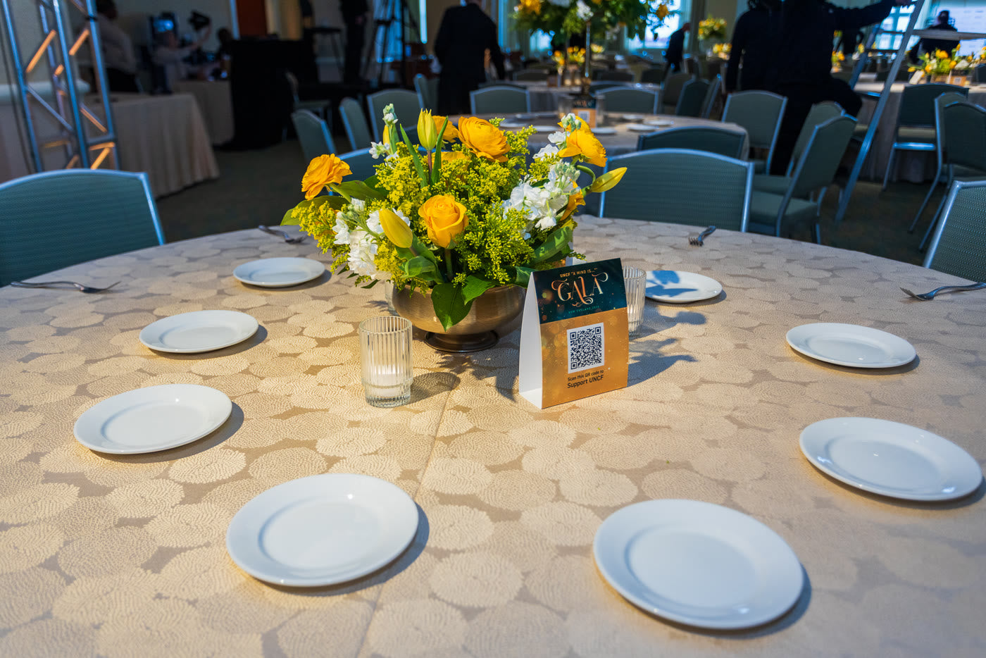 Golden centerpiece and gala table setting up close
