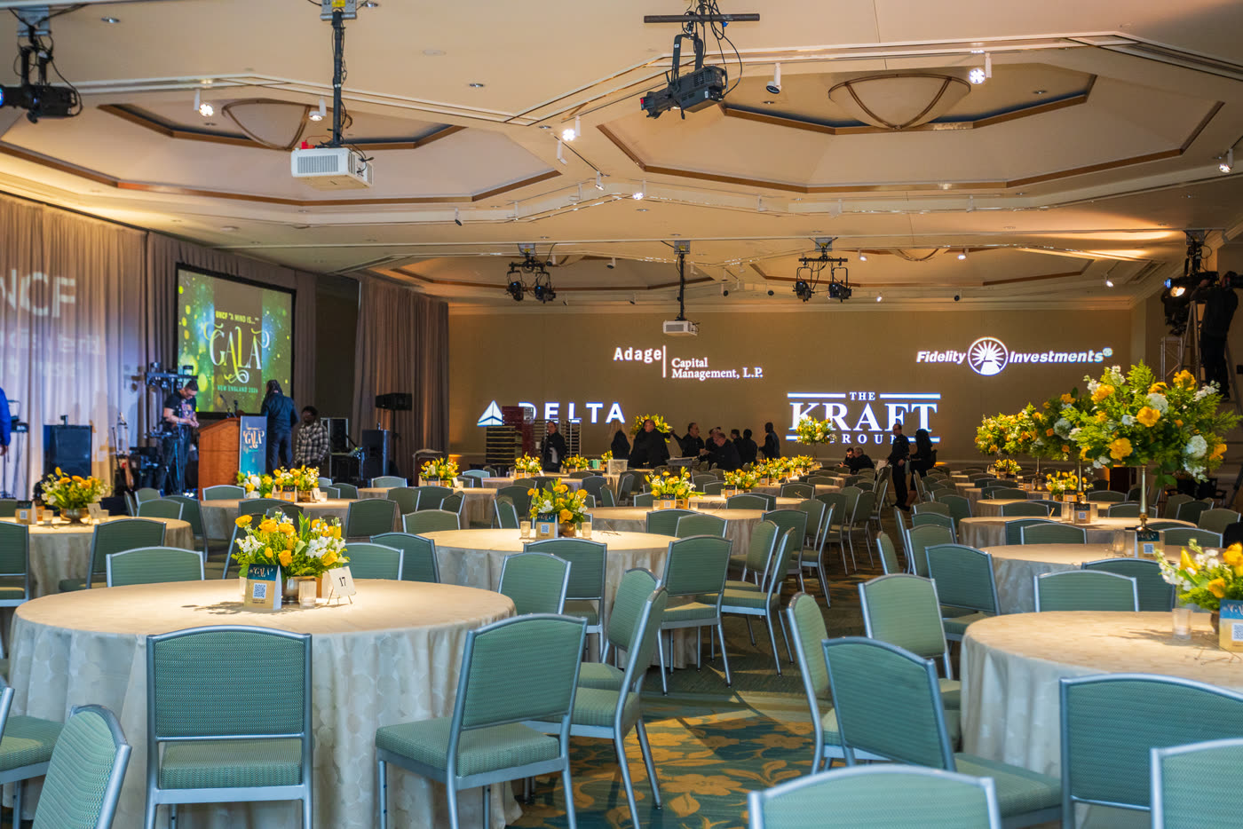Sponsor ballroom with yellow centerpieces on every table