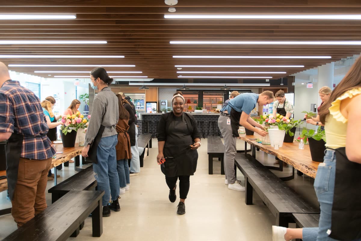 An open workshop class in session at long tables